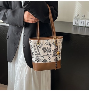 Detail of vintage canvas tote with leather trim and traditional Chinese embroidery