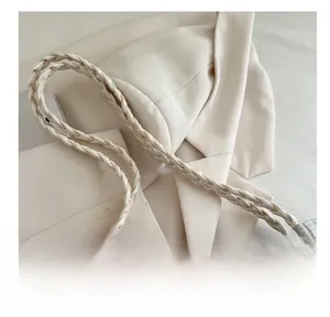 Detail of grey textured tote bag with white braided handle and gold D-ring hardware