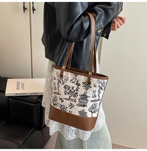 Detail of vintage tote bag featuring ink landscape and rabbit pattern with leather trim