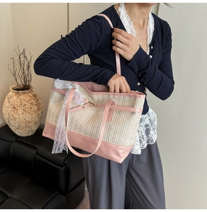 Pink and beige straw tote bag with lace ribbon detail shown as casual shoulder bag