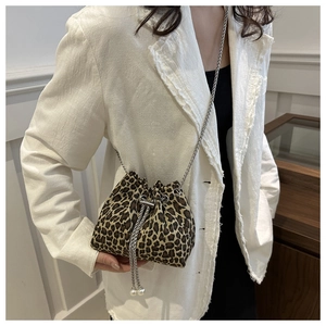 Detail of leopard print bucket bag with metal chain strap and pearl drawstring charms
