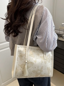 Off-white tote bag with butterfly print, long tassel, and spacious shoulder design