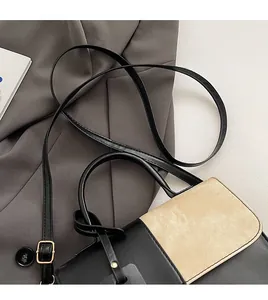 Close-up of adjustable strap and minimalist color-block contrast leather handbag