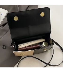 Top view of color-block flap bag showing large interior space for daily essentials