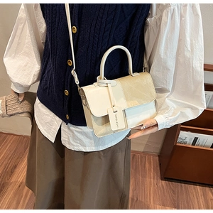 Lifestyle shot of model wearing the beige and khaki patchwork square crossbody handbag