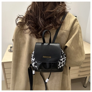 Close-up of leopard print patchwork backpack with drawstring closure and fashion flap