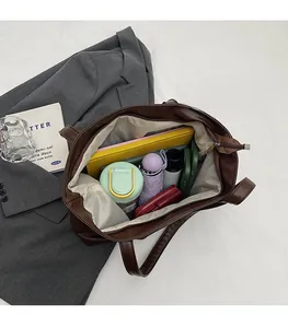 Deep coffee tote bag showing large interior capacity with umbrella, notebook, and bottle