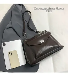 Deep brown retro tote bag showing size comparison with a tablet and smartphone
