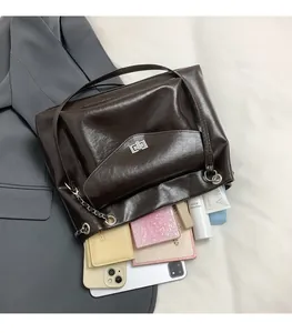 Internal view of brown vintage shoulder bag showing large capacity and chain strap