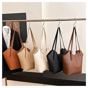 Row of minimalist tote bags in diverse colors showing adjustable shoulder straps