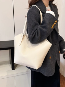 Minimalist beige pebble leather tote bag for women with adjustable shoulder strap