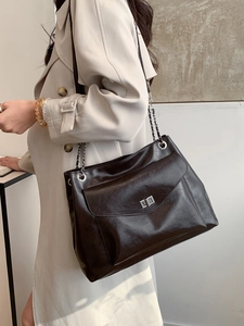 Large dark brown chain tote bag in glossy leather, perfect for stylish daily commuting