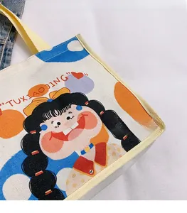 Close-up of canvas tote bag with cartoon girl print and reinforced stitched edges