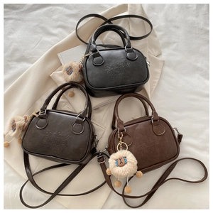 Three minimalist crossbody bags in black, dark coffee and brown with sheep pendants