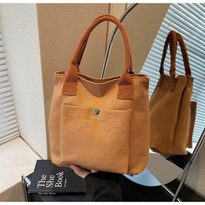 Bolso tote minimalista de lona caqui con bolsillo frontal y asas dobles para mujer
