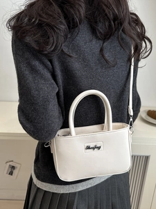 Creamy white PU leather handbag with silver hardware and detachable crossbody strap