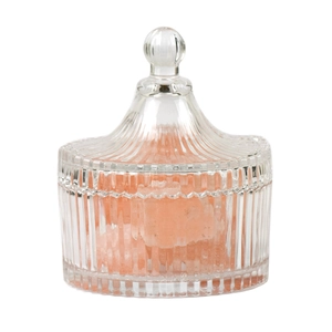 Ribbed glass aromatherapy lamp filled with natural pink crystal stones on white background