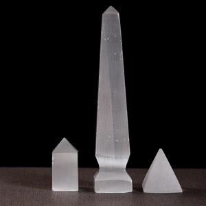 Natural selenite crystal set with tower, pillar, and pyramid on black background
