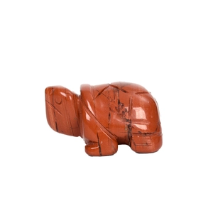 Hand-carved red jasper turtle figurine with natural black mineral veins on white background