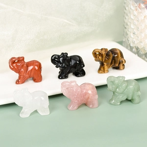 Set of six natural crystal elephant statues including rose quartz and obsidian stones