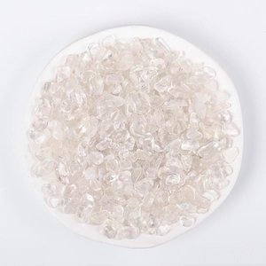 Polished natural white crystal chips in a white ceramic dish for home decor and healing