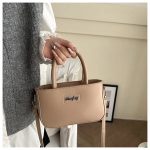Detail of beige PU leather mini bag with silver Shanfeng logo and handle