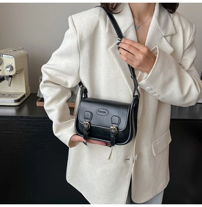 Classic black vintage crossbody bag with dual buckles and embossed fashion text