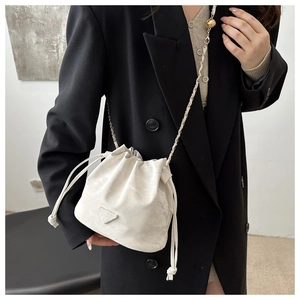 Detail of white marble pattern bucket bag with chain strap and drawstring closure