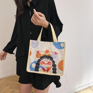 Minimalist canvas tote bag with cute cartoon illustration and yellow strap handles