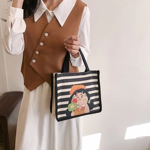 Retro canvas handbag featuring black and white stripes and cute cartoon girl illustration