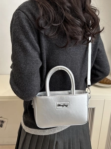 Silver metallic rectangular handbag with top handles and adjustable shoulder strap