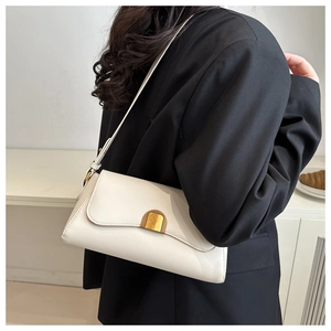 French retro white leather shoulder bag with vintage gold buckle shown on black suit