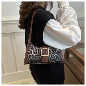 Detail of leopard print hobo bag with brown leather strap and gold metal buckle