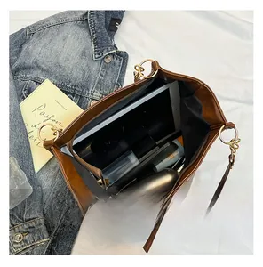 Spacious interior of brown wax leather tote bag with pocket for tablets and daily items