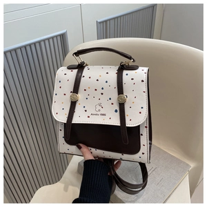 Detail view of vintage backpack featuring colorful polka dot flap and rabbit logo print