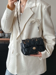 Chic black quilted crossbody bag with gold chain strap and metallic twist-lock closure
