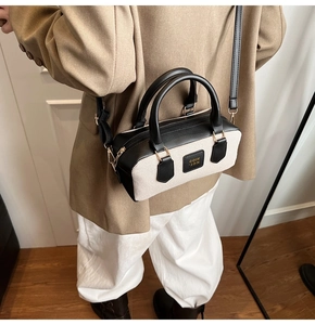 Detail shot of the retro contrast color crossbody bag with gold hardware and strap