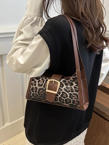 Vintage Y2K leopard print underarm bag with dark brown leather trim and gold buckle