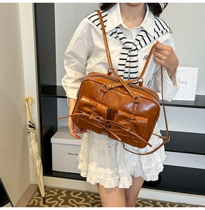 Detailed view of brown PU leather backpack with decorative bows and adjustable straps