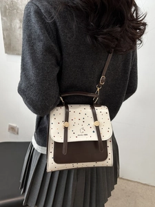 Retro polka dot shoulder bag in cream and brown leather with gold buckle detail