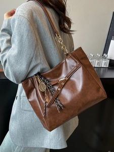 Retro deep brown oil wax leather tote bag with gold chain strap and tennis racket charm