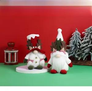 Close-up of Christmas gnomes with reindeer antlers and bows in festive decor