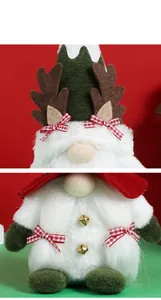 Detail of Christmas gnome plush with deer antlers, plaid bow and golden bell buttons