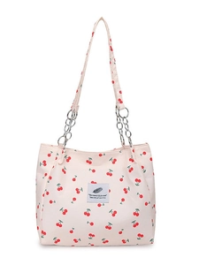 Pink canvas tote bag with cherry print, silver chain straps, and a central fabric patch