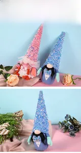 Detail of pink and blue sequined wedding gnomes with lace and bowknot decorations
