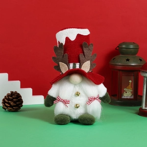 Christmas reindeer gnome doll with plush beard and antlers on festive red background