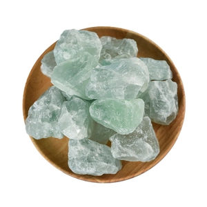 Natural green fluorite raw stones in a wooden tray for home decor and aromatherapy