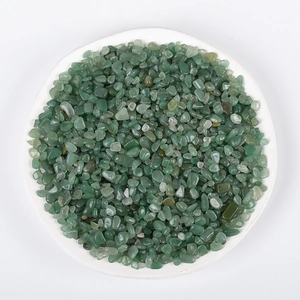 Polished green aventurine quartz crystal gravel in a white ceramic dish
