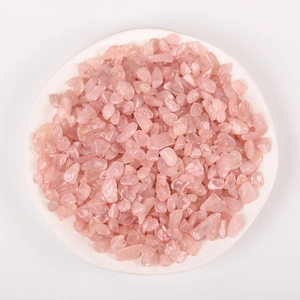 Polished natural rose quartz crystals in white ceramic bowl for home decor and healing