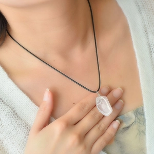Handmade wire wrapped natural clear crystal stone pendant on black cord necklace